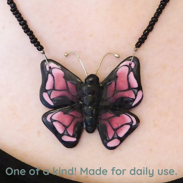 Butterfly in pink and black Polymer clay pendant necklace. Super soft matte finish. Silver plated clasp and chain. Free form necklace.