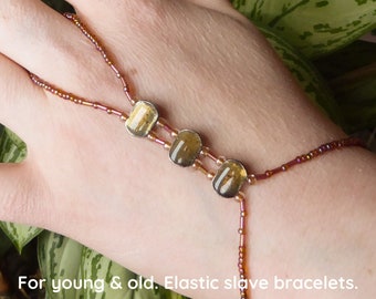 Topaz enamel in nickel free metal spacer bars. Pink orange elastic slave bracelet. Beaded Bracelet ring. Hand jewellery. Finger bracelet.