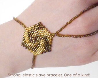 Hexagonal spiral beadwork. Elastic slave bracelet. Gold iris metallic delica beads. Beaded hand finger jewelry. Hand jewelry. Ring bracelet.