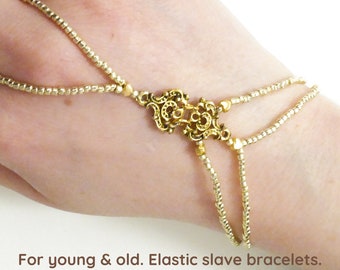 Gold metal details, nickel free. Gold metallic, elastic slave bracelet. Hand jewellery. Finger bracelet. Ring bracelet.Hand chain ring