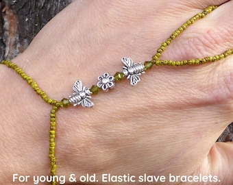 Silver metal flower and beez. Lime green elastic slave bracelet. Hand jewelry. Finger bracelet. Hand jewelry. Ring bracelet. Hand bracelet.