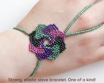 Beadwork flower with different metallic seed beads. Elastic slave bracelet. Gold plated metallic delica beads. Ring bracelet.