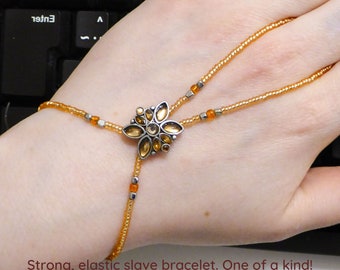 Orange enamel. Nickel free silver metal flower spacer. Elastic slave bracelet. Hand jewellery. Finger bracelet. Hand jewelry. Hand bracelet.