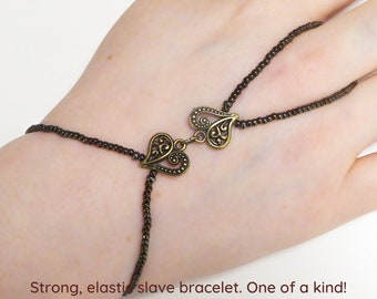 Two cute nickel free bronze hearts. Bronze iris metallic elastic slave bracelet. Hand jewelry. Bracelet ring. Finger bracelet. Hand chain.