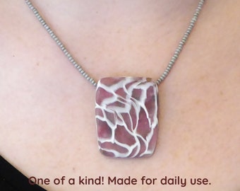 Pink Polymer clay pendant necklace. Translucent white lace pattern. Silver plated clasp and chain. Beaded free form seed beads necklace.