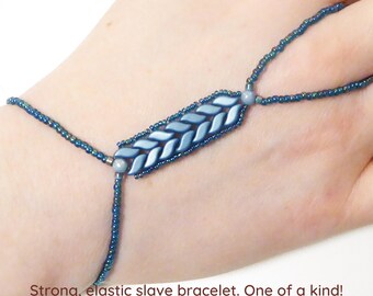 Slender beadwork with light petrol pearl StormDuo beads. Baby blue luster mini RounDuo beads. Strong elastic slave bracelet.