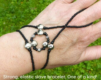 Nickel free silver metal spacer bars. Black elastic slave bracelet. Beaded Bracelet ring. Hand jewellery. Finger bracelet. Ring bracelet.