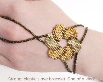 Flower beadwork with different gold iris metallic delica beads. Elastic slave bracelet. Gold plated metallic delica beads. Ring bracelet.