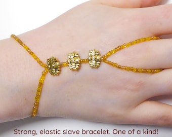 Nickel free gold colored metal Lotus flowers. Yellow  elastic slave bracelet. Finger bracelet. Hand jewelry. Ring bracelet. Hand bracelet.