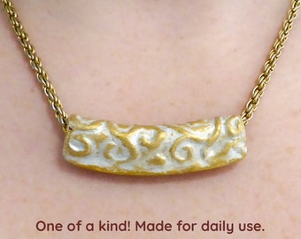 3D tube of gold and silver Polymer clay. Soft matte finish. Nickel free gold chain and clasp. Free form beaded seed beads necklace