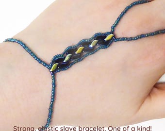 Slender beadwork with blue yellow metallic and black StormDuo beads. Teal transparent rainbow seed beads. Strong elastic slave bracelet.