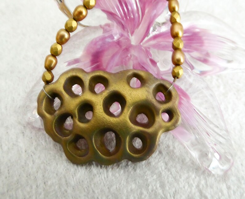 Gold polymer clay in a 3D net. Beautiful gold colored freshwater pearls. Faceted gold colored glass beads. Bronze colored clasp and chain. image 3