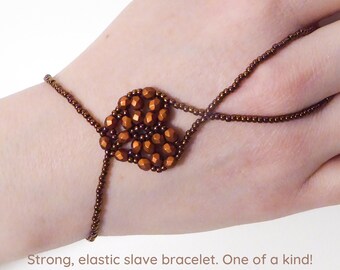 Matte orange copper metallic faceted heart. Elastic slave bracelet. Bronze metallic seed beads. Ring bracelet. Hand jewelry Finger jewelry