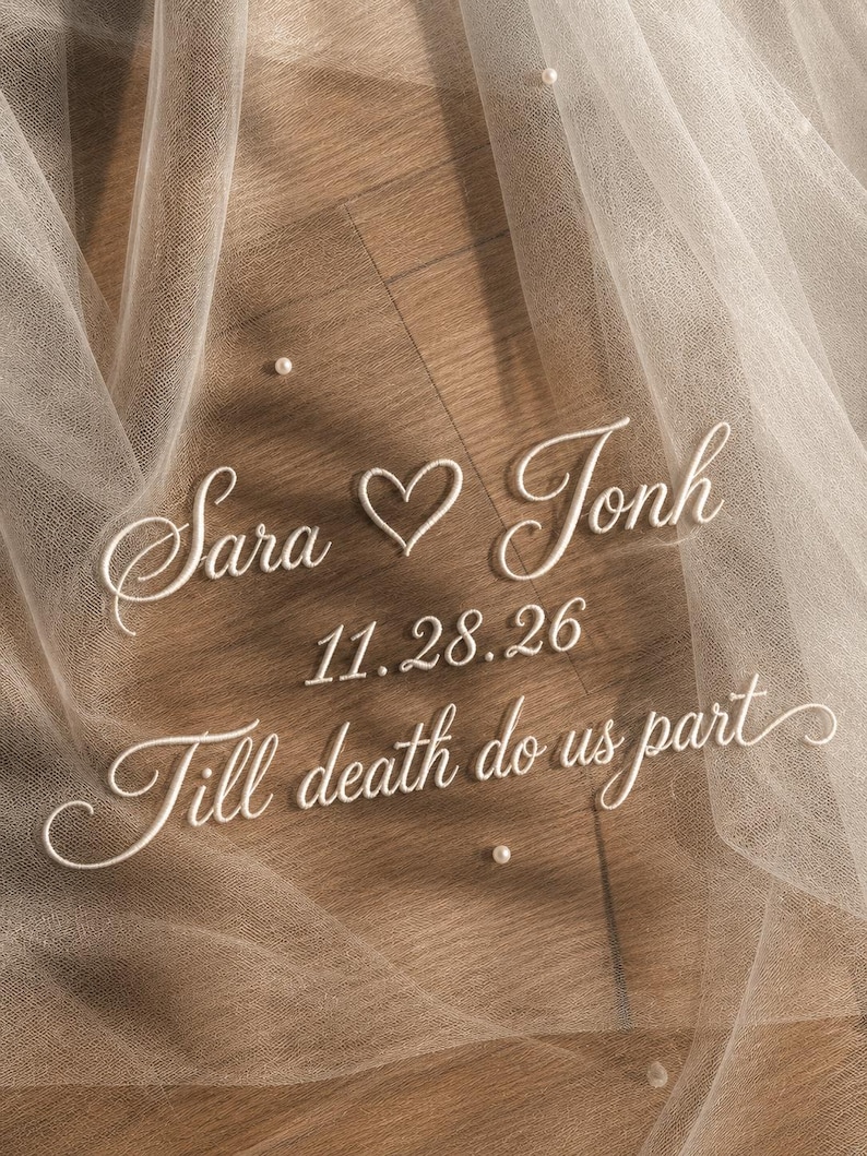 May include: A sheer, ivory wedding veil with embroidered text: "Sara ♡ Jonh", "11.28.26", and "Till death do us part". Small, scattered pearls add delicate detail to the tulle fabric.