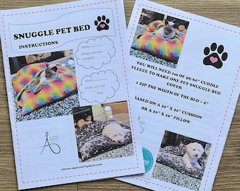 May include: Two instruction sheets for a Snuggle Pet Bed. The sheets feature images of cats and dogs on pet beds. Text includes "Snuggle Pet Bed Instructions" and "You will need 1m of 58/60" cuddle fleece to make one pet snuggle bed cover."
