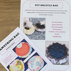 May include: Instructions for making a drawstring snuffle bag for pets. The instructions include a photo of a dog sniffing a snuffle bag and a photo of a drawstring bag with a blue fabric interior.
