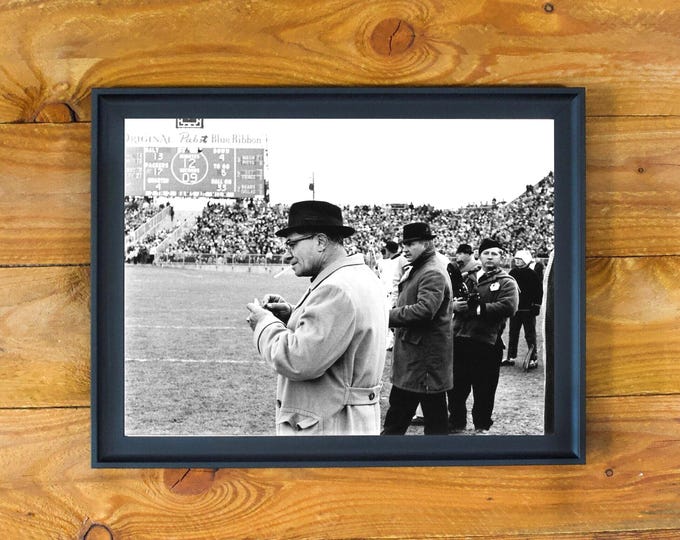 Vince Lombardi - Image of Interest - Legendary Green Pay Coach Smoking a Cigarette During a Game - Framed Sports Wall Poster
