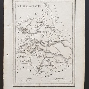 May include: A detailed black and white map of the Eure-et-Loir region in France, featuring towns like Chartres and Dreux, and rivers such as the Eure and Loire. The map includes place names and scale indicators.