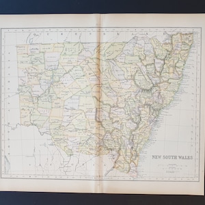 May include: A vintage map of New South Wales, Australia, featuring detailed geographical information and place names. The map is printed on aged paper with a beige and green colour scheme. The title "New South Wales" is displayed at the bottom right.