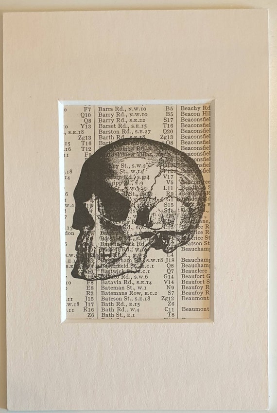 Handprinted skull on original vintage page in mount