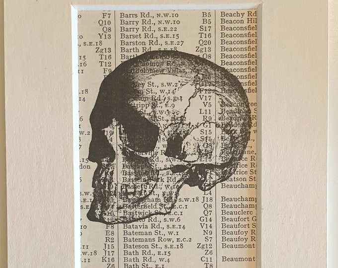 Handprinted skull on original vintage page in mount