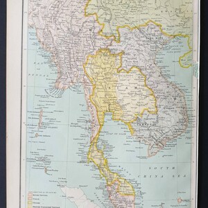May include: Vintage map of Farther India, showing detailed geographical features. The map uses colour-coded borders to distinguish regions such as Siam, Burma, and French territory. Printed on aged paper, it includes text and labels.