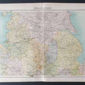 May include: Vintage map of England and Wales, showing detailed geographical features. The map is divided into sections with various colours, including green, yellow, and purple. The title "ENGLAND & WALES" is printed at the top.