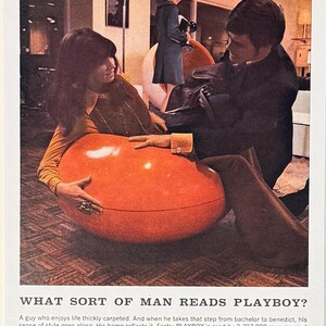 May include: A vintage 1968 magazine advertisement featuring a large, glossy orange egg-shaped chair. The text reads: WHAT SORT OF MAN READS PLAYBOY? A guy who enjoys life thickly carpeted. And when he takes that step from bachelor to benedict, his sense of style goes along.