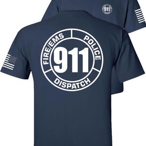 May include: Navy blue t-shirts with white graphics. The front shirt displays a small "911" logo. The back shirt features a large circular design with "911 DISPATCH" and "FIRE/EMS POLICE" text. An American flag is on the left sleeve.