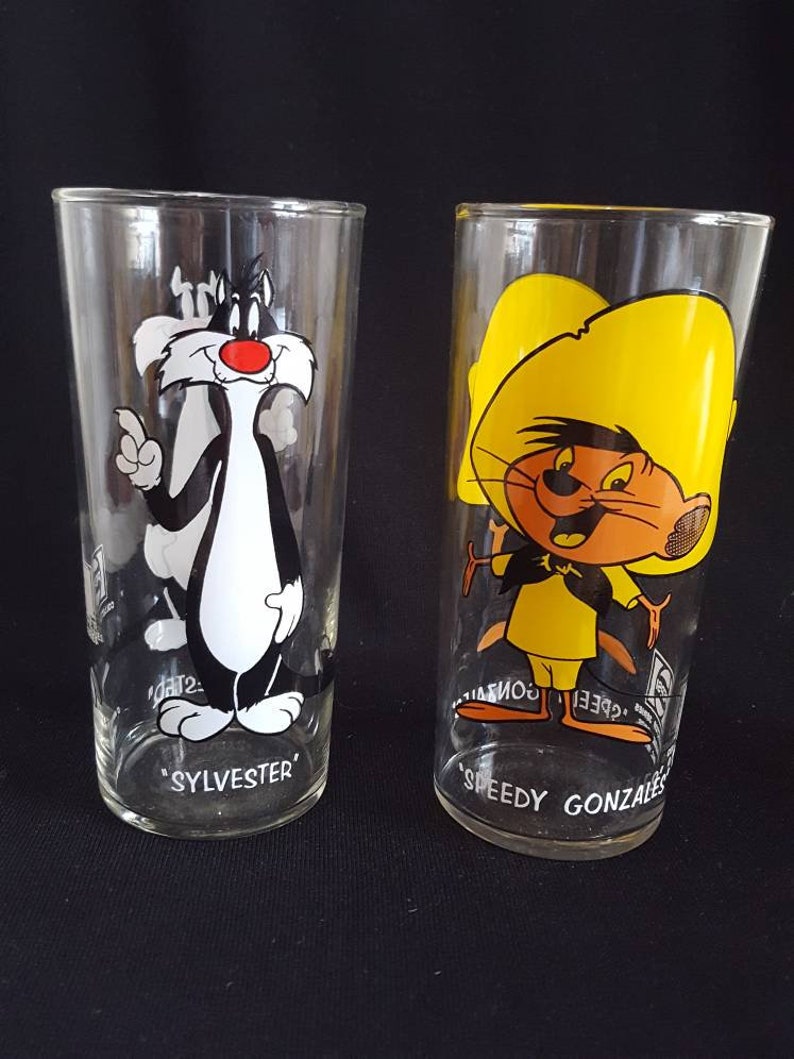 original thin glassware with white lettering. Set of 2 Warner Brothers Sylvester and Speedy Gonzales Tumblers