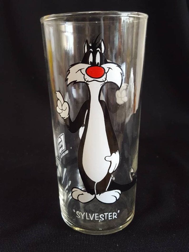 original thin glassware with white lettering. Set of 2 Warner Brothers Sylvester and Speedy Gonzales Tumblers