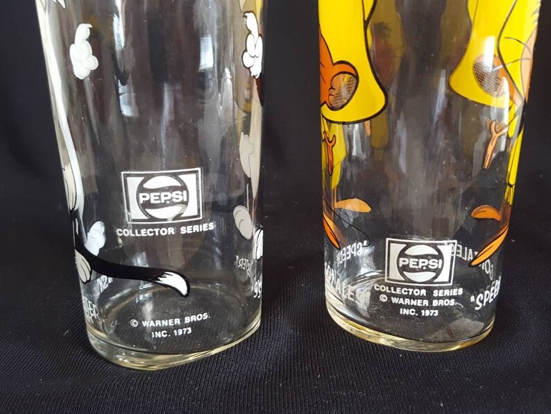 original thin glassware with white lettering. Set of 2 Warner Brothers Sylvester and Speedy Gonzales Tumblers