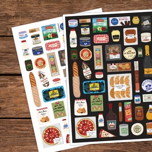 May include: Two sheets of stickers featuring illustrations of French food items. The stickers are on white and black backgrounds. The stickers include images of bread, cheese, wine, pastries, and other French foods.