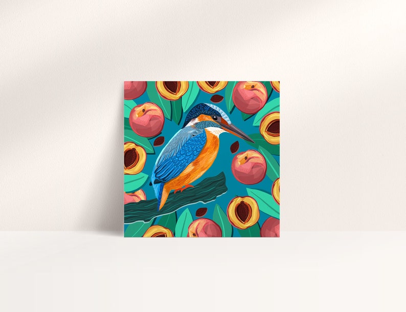 May include: A blue and orange kingfisher bird perched on a branch with a background of peach fruit and green leaves. The bird has a long, pointed beak and a blue head. The peaches are ripe and juicy, with a yellow flesh and a red skin.
