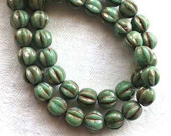Lot of 25 6mm pressed Czech glass melon beads,  pea green picasso beads  with coral accents C0901