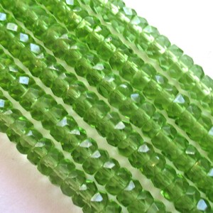 Fifty 6 x 3mm Czech glass faceted rondelle beads - transparent olivine green spacers or rondelles C0037