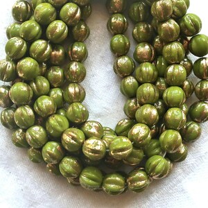 25 Czech pressed glass melon beads.  6mm Avocado Green with gold accents, C00101
