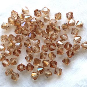 Lot of 24 6mm Celsian Czech Preciosa Crystal bicone beads, faceted golden amber glass bicones  C7801