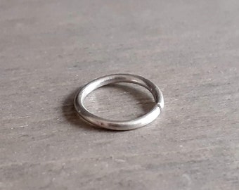 May include: A silver hoop earring, a type of jewelry worn in the ear.