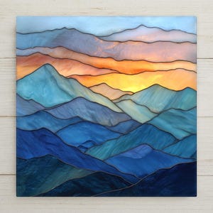 May include: A square stained glass panel depicting a mountain landscape at sunset. The scene features layered mountain ranges in shades of deep blue, teal, and light blue, set against a vibrant sky of orange, yellow, and soft pink hues.
