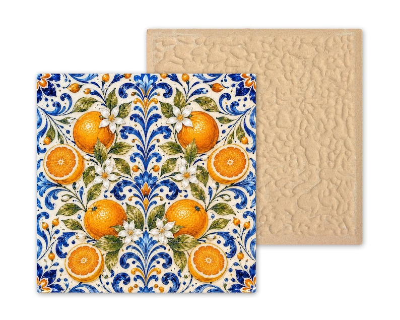 May include: A square coaster featuring a vibrant pattern of bright orange citrus fruits, green leaves, and white blossoms set against a deep blue and white scrollwork background. The reverse side of the coaster has a textured, light beige surface.