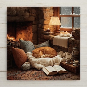 May include: An orange tabby cat sleeps curled on a white textured blanket near a stone fireplace. An open book rests on a patterned rug in the foreground. A table lamp, candles, and a window showing falling snow are visible in the background.