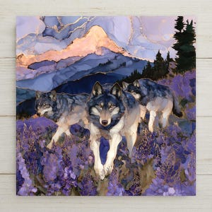 May include: A square wall art print featuring three wolves walking through a field of purple lupine flowers. The background displays a mountain range with soft pink and blue hues, accented by gold metallic veins throughout the entire composition.