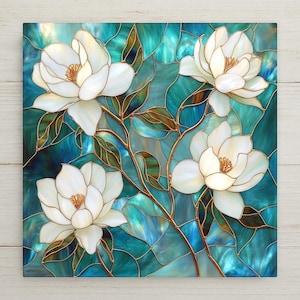 Bring timeless elegance into your home with this luminous stained glass magnolia tile. Four pearl escent white magnolia blooms, outlined in delicate metallic gold, flow gracefully across a rich mosaic of teal, turquoise, and aqua glass. The swirling branches, golden leaves, and intricate line work echo the sophistication of Art Nouveau and Tiffany glass. Perfect for collectors or anyone who loves botanical art with a serene, luxurious touch.