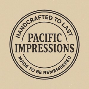A black and white circular logo with the text "HANDCRAFTED TO LAST" and "PACIFIC IMPRESSIONS" inside it.