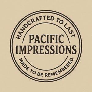 A black and white circular logo with the text "HANDCRAFTED TO LAST" and "PACIFIC IMPRESSIONS" inside it.