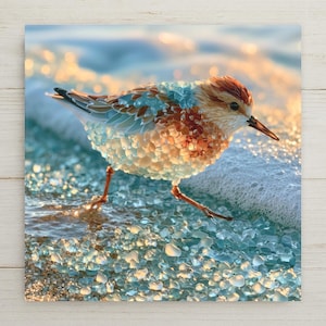 May include: A bird figure crafted from small, translucent blue and amber glass pieces, standing on a shore covered in scattered light blue glass pebbles. The bird has a pointed beak and a textured body with layered, multi-colored glass feathers.