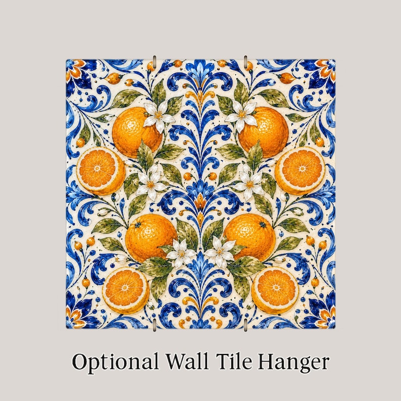 May include: A square ceramic tile featuring a symmetrical pattern of bright orange citrus fruits, white blossoms, and green leaves set against a cream background with intricate blue and gold scrolling acanthus leaf motifs and the text Optional Wall Tile Hanger.