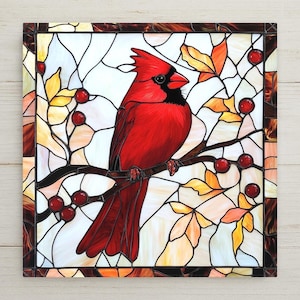 Red cardinal ceramic tile with stained glass design wall art. A beautiful memorial or sympathy gift, ideal for bird lovers or remembrance wall decor. Features a vivid red bird with berries and fall leaves, symbolizing peace, comfort, and presence. Crafted from ceramic with a glossy finish, perfect for walls, altars, or as a thoughtful seasonal gift. A timeless piece of nature-inspired art to celebrate life and honor memory with color and grace.