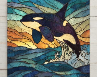 May include: A square wall art piece featuring a stained glass style illustration of an orca whale breaching the water. The design uses dark blue, black, and white tones for the whale, set against a background of swirling teal, orange, and yellow.